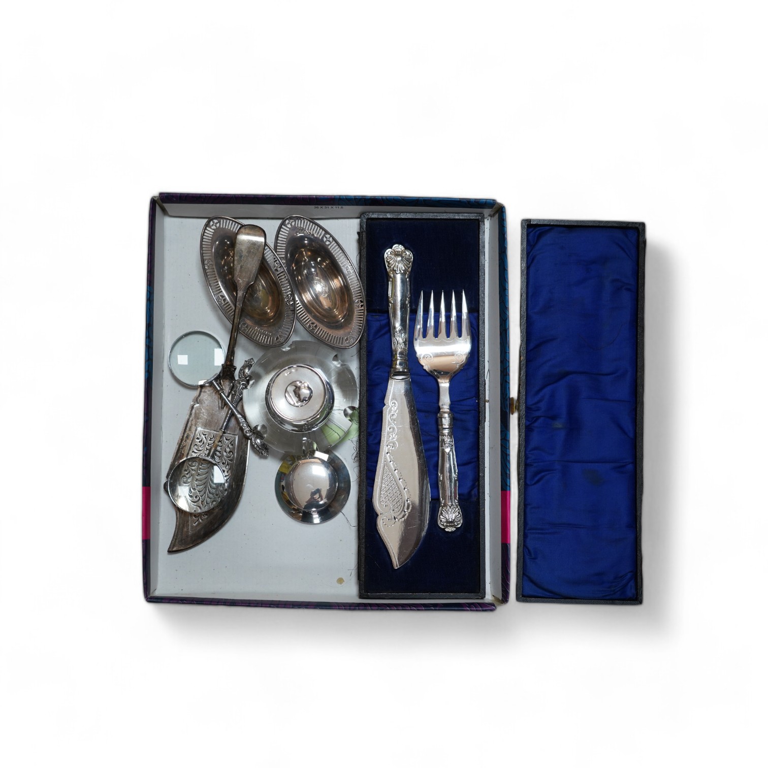 Sundry silver items including two inkwells, a William IV fiddle pattern fish slice, a pair of bonbon dishes and two handled magnifying glasses (one a.f.), together with a cased pair of plated fish servers. Condition - po